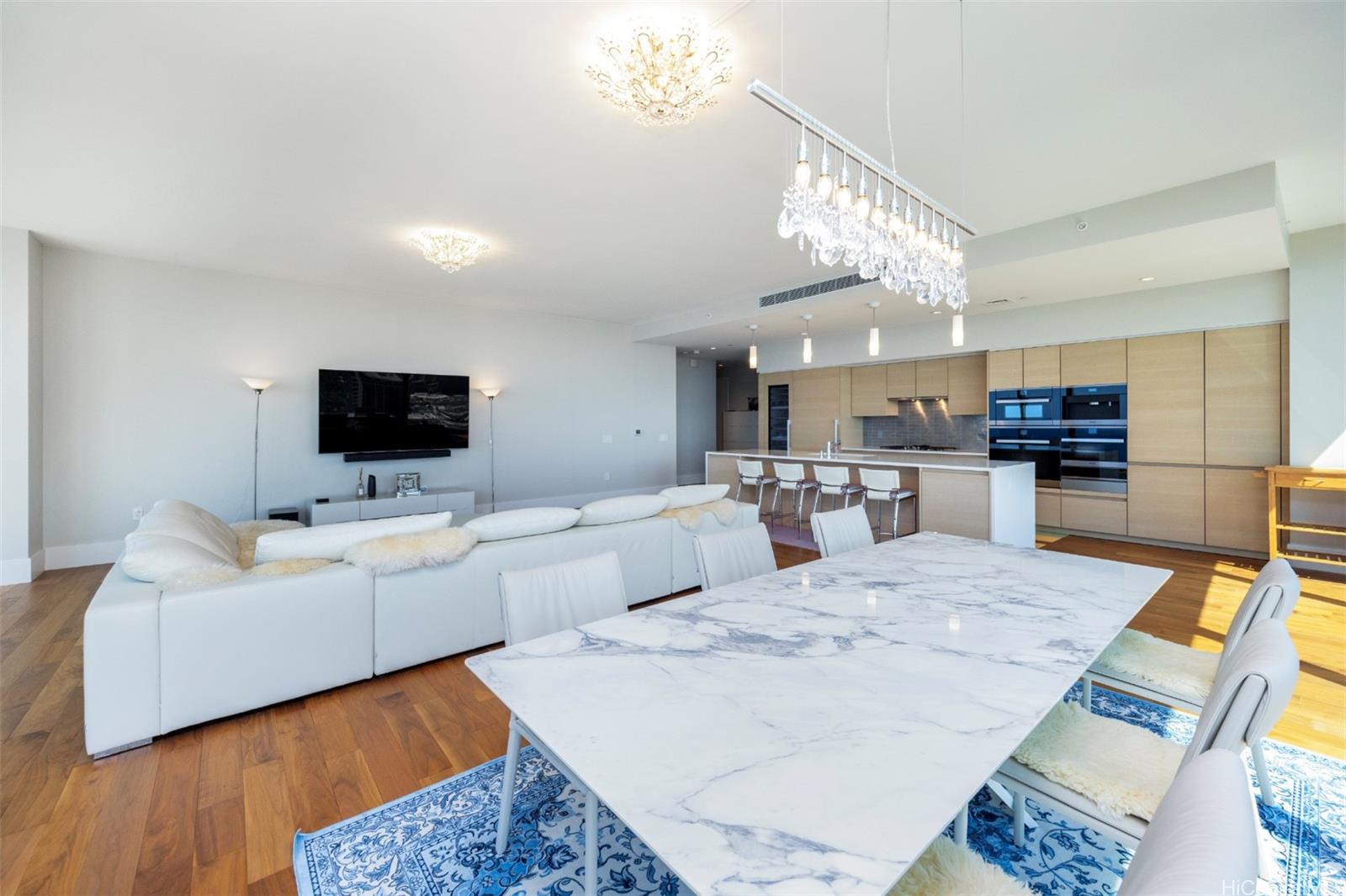 1108 Auahi Street, Unit 3300 Honolulu, HI 96814 - Photo 11 of 25 a living room with furniture and a flat screen tv