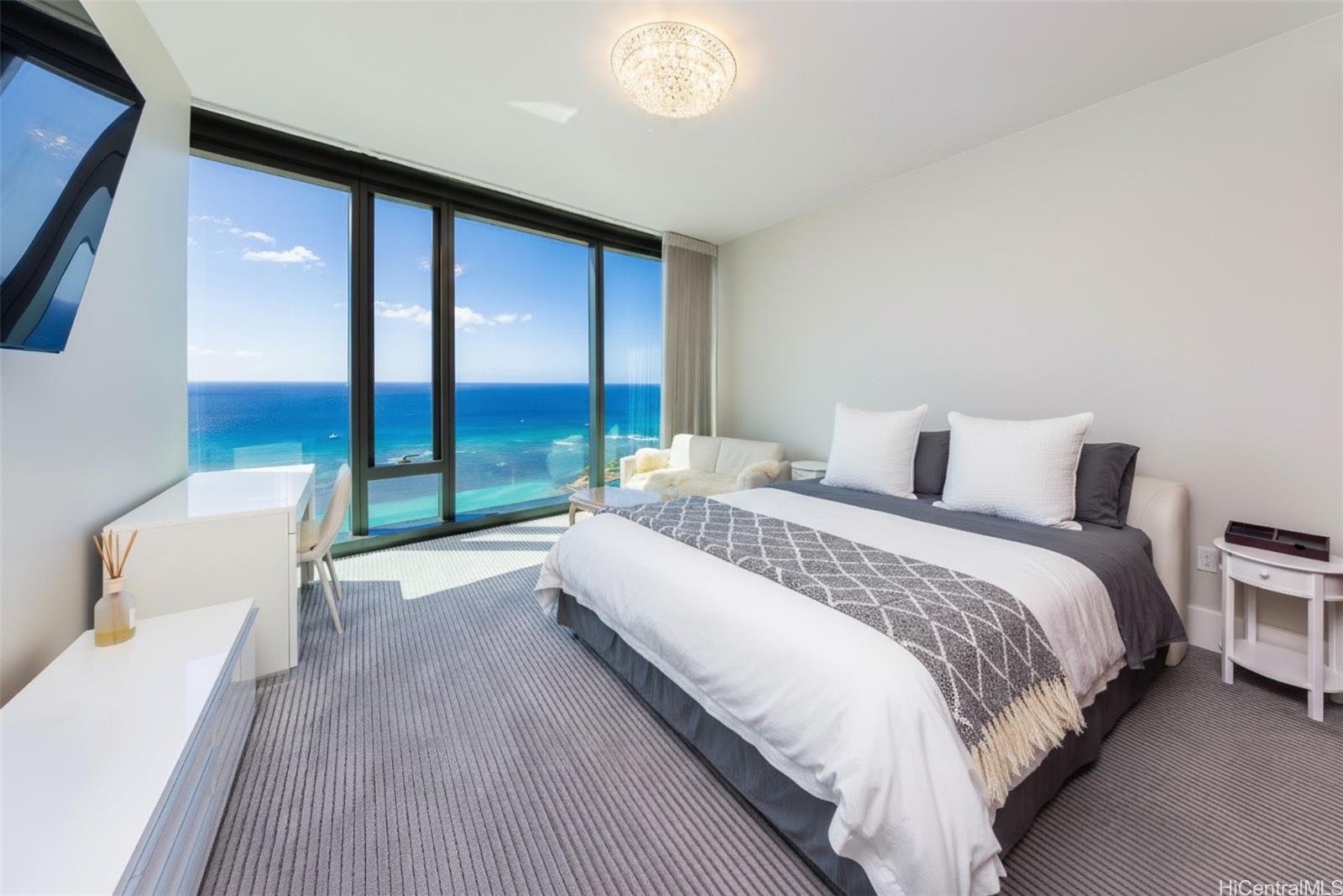 1108 Auahi Street, Unit 3300 Honolulu, HI 96814 - Photo 14 of 25 a bedroom with a bed and a large window