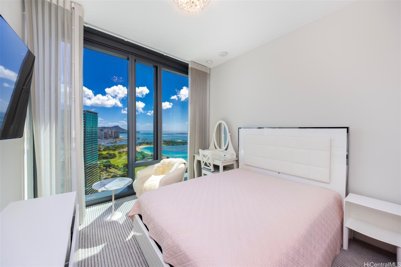 1108 Auahi Street, Unit 3300 Honolulu, HI 96814 - Photo 17 of 25 a bedroom with a bed and a large window