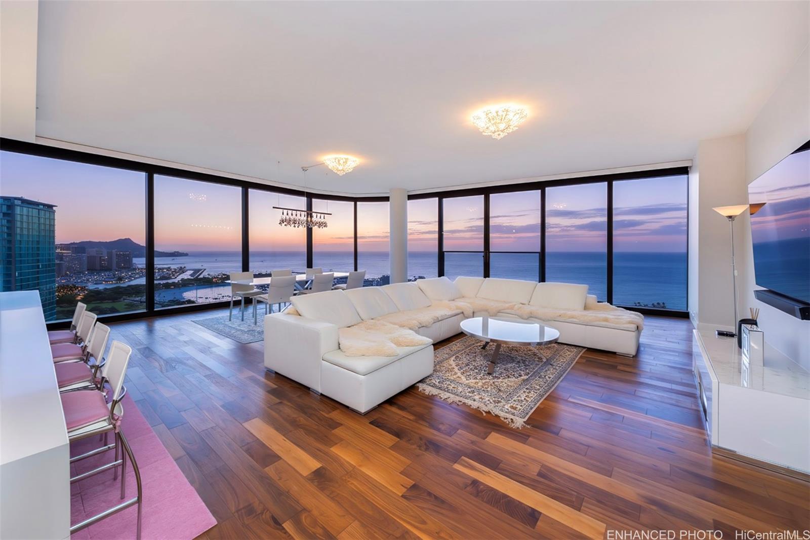 1108 Auahi Street, Unit 3300 Honolulu, HI 96814 - Photo 2 of 25 a living room with furniture and a floor to ceiling window