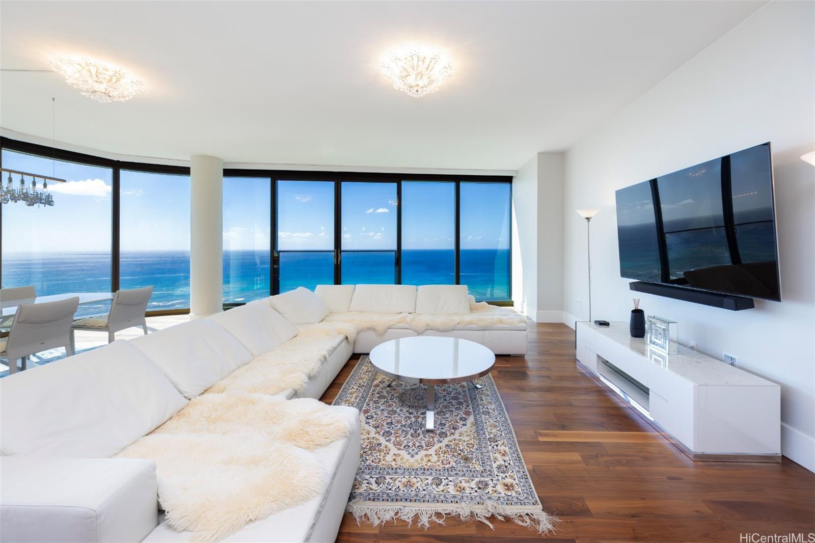 1108 Auahi Street, Unit 3300 Honolulu, HI 96814 - Photo 4 of 25 a living room with couches and a flat screen tv