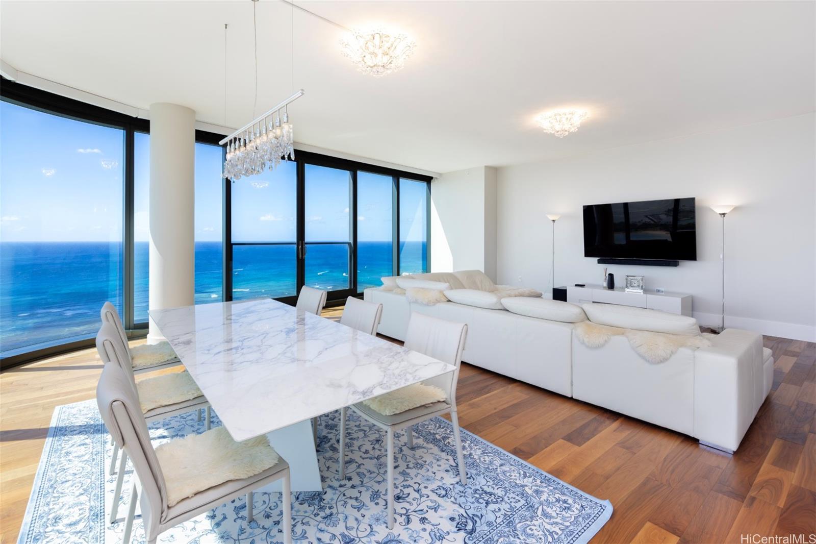 1108 Auahi Street, Unit 3300 Honolulu, HI 96814 - Photo 5 of 25 a living room with furniture and a flat screen tv