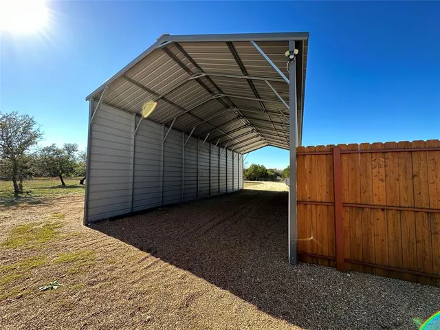 a view of wooden floor and a window in a room