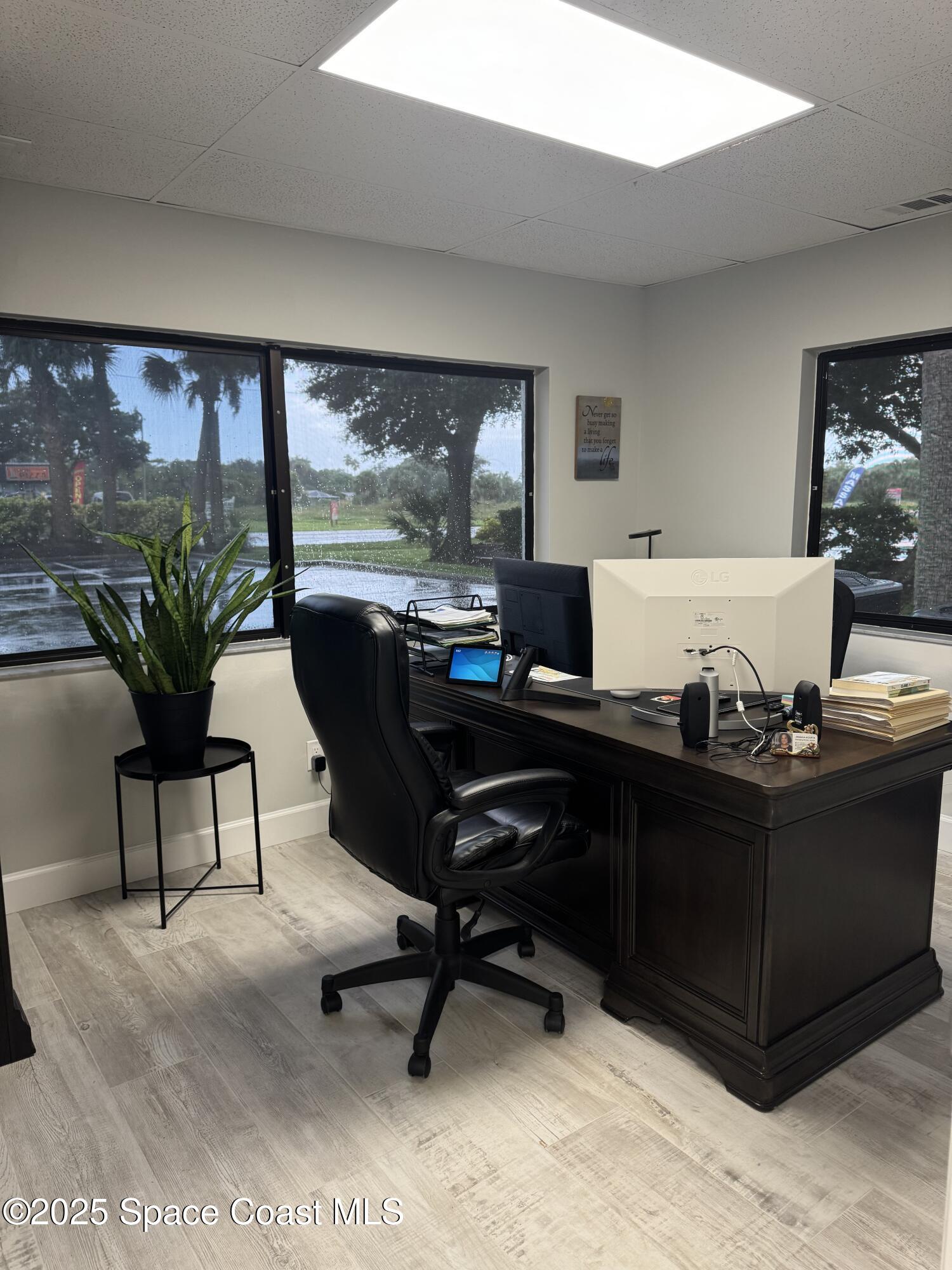 700 North Wickham Road, Unit 101 Melbourne, FL 32935 - Photo 7 of 12 a living room with furniture and a large window