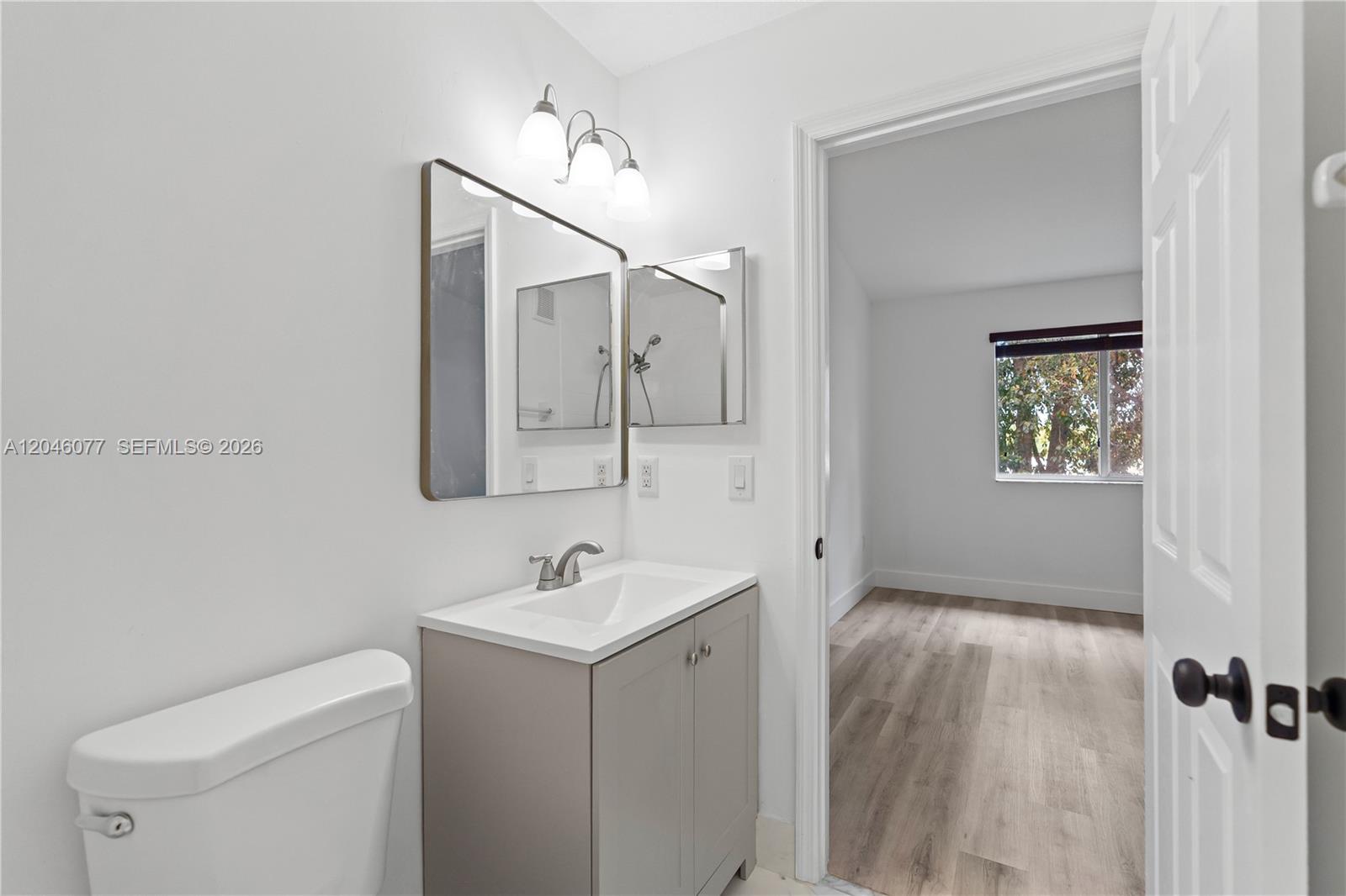 2930 Southeast 12th Road, Unit 20431 Homestead, FL 33035 - Photo 27 of 37 a bathroom with a toilet sink and mirror
