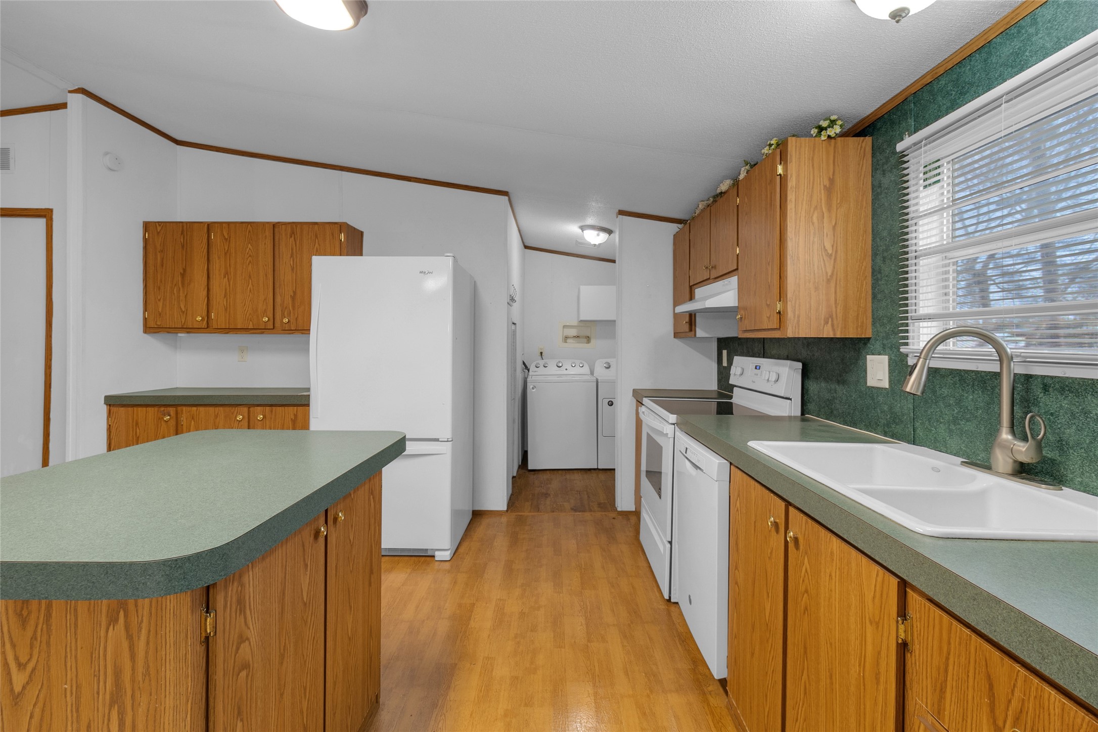 22094 Spear Road Porter, TX 77365 - Photo 13 of 45 a kitchen with a sink a refrigerator and a stove