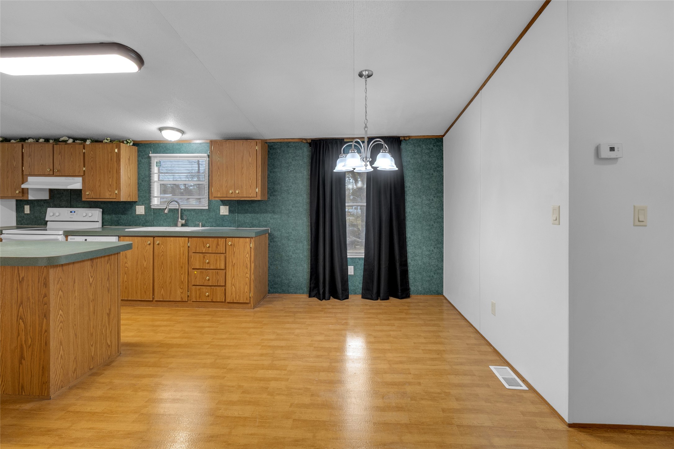 22094 Spear Road Porter, TX 77365 - Photo 14 of 45 a large white kitchen with kitchen island a sink stainless steel appliances and cabinets