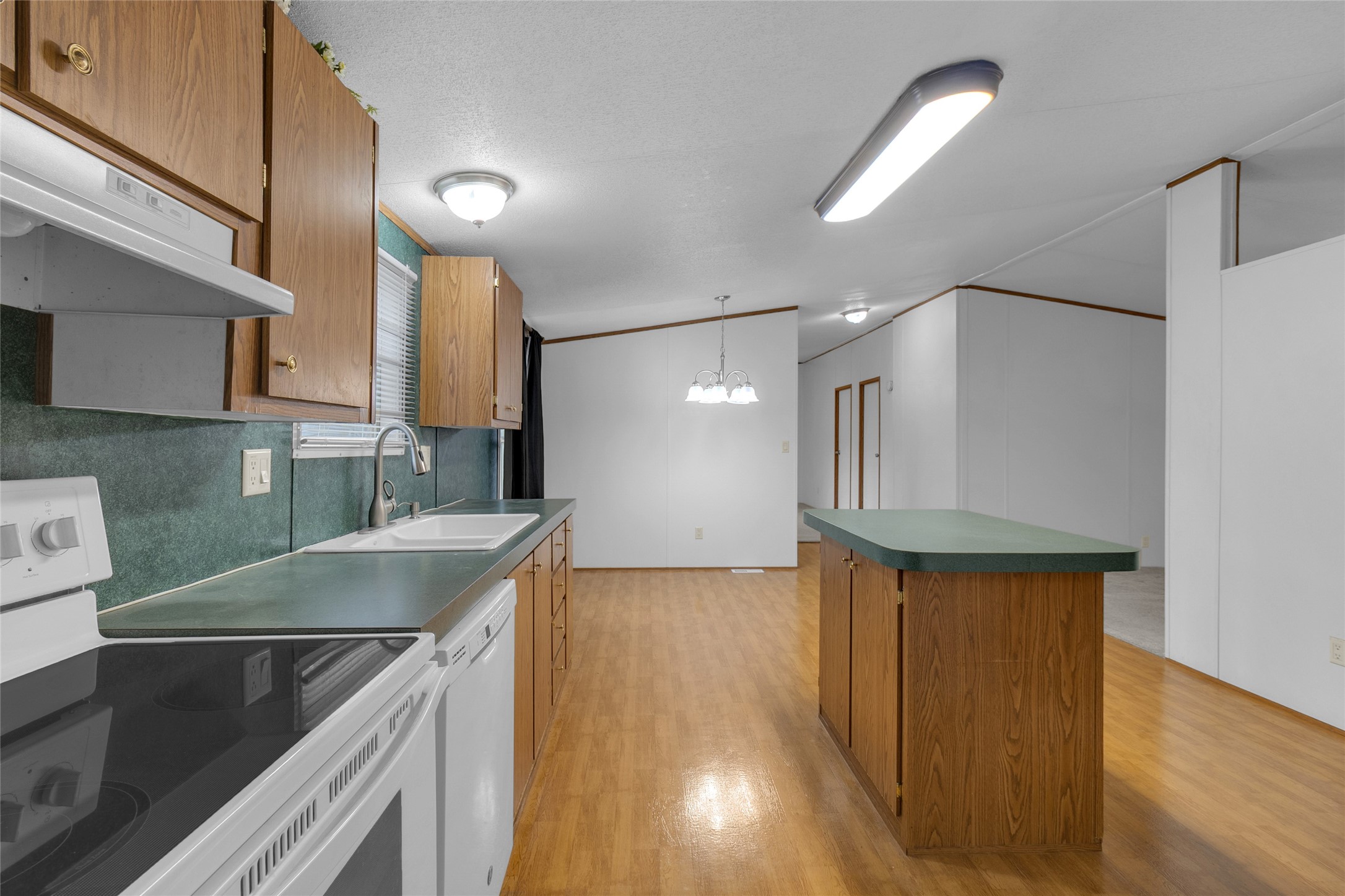 22094 Spear Road Porter, TX 77365 - Photo 9 of 45 a kitchen with stainless steel appliances granite countertop a sink a stove and a wooden floors