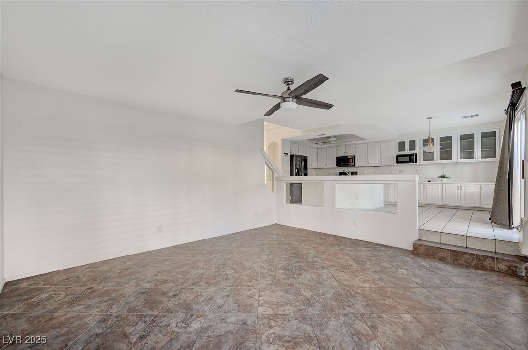 8776 Country View Avenue Las Vegas, NV 89129 - Photo 15 of 43 Unfurnished living room featuring ceiling fan