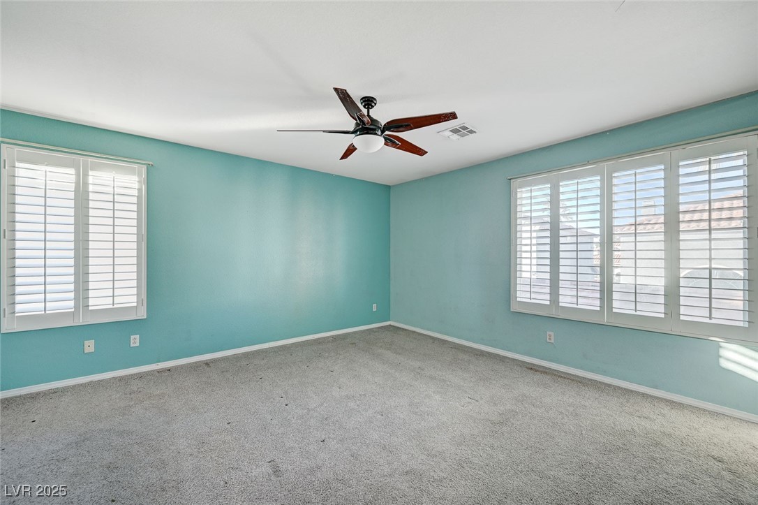 8776 Country View Avenue Las Vegas, NV 89129 - Photo 19 of 43 Empty room featuring carpet and ceiling fan