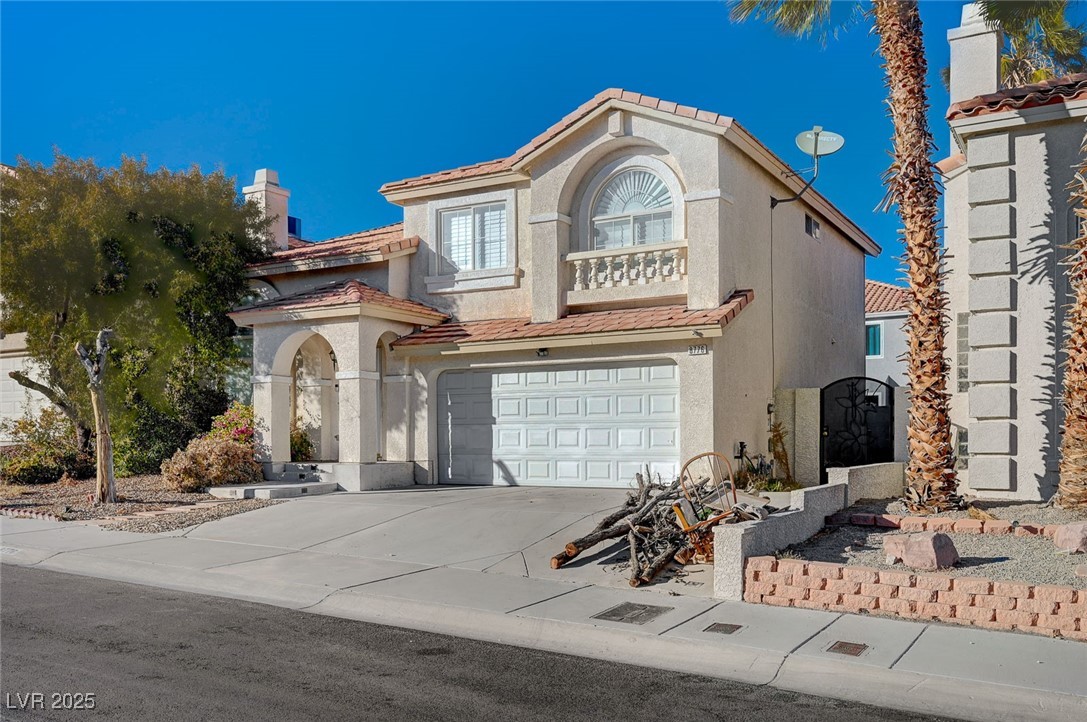8776 Country View Avenue Las Vegas, NV 89129 - Photo 2 of 43 Mediterranean / spanish-style home with a tiled roof, driveway, an attached garage, and stucco siding