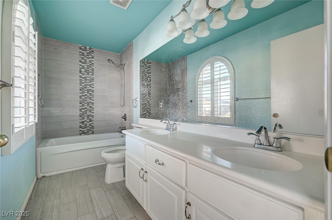 8776 Country View Avenue Las Vegas, NV 89129 - Photo 23 of 43 Full bathroom featuring bathing tub / shower combination, double vanity, and light wood-style floors