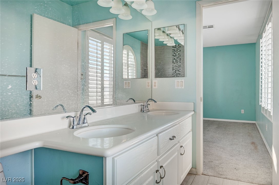 8776 Country View Avenue Las Vegas, NV 89129 - Photo 25 of 43 Bathroom with plenty of natural light and double vanity