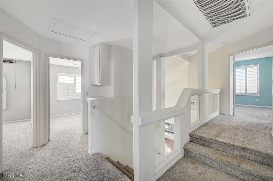 8776 Country View Avenue Las Vegas, NV 89129 - Photo 28 of 43 Stairway with carpet floors, plenty of natural light, and attic access