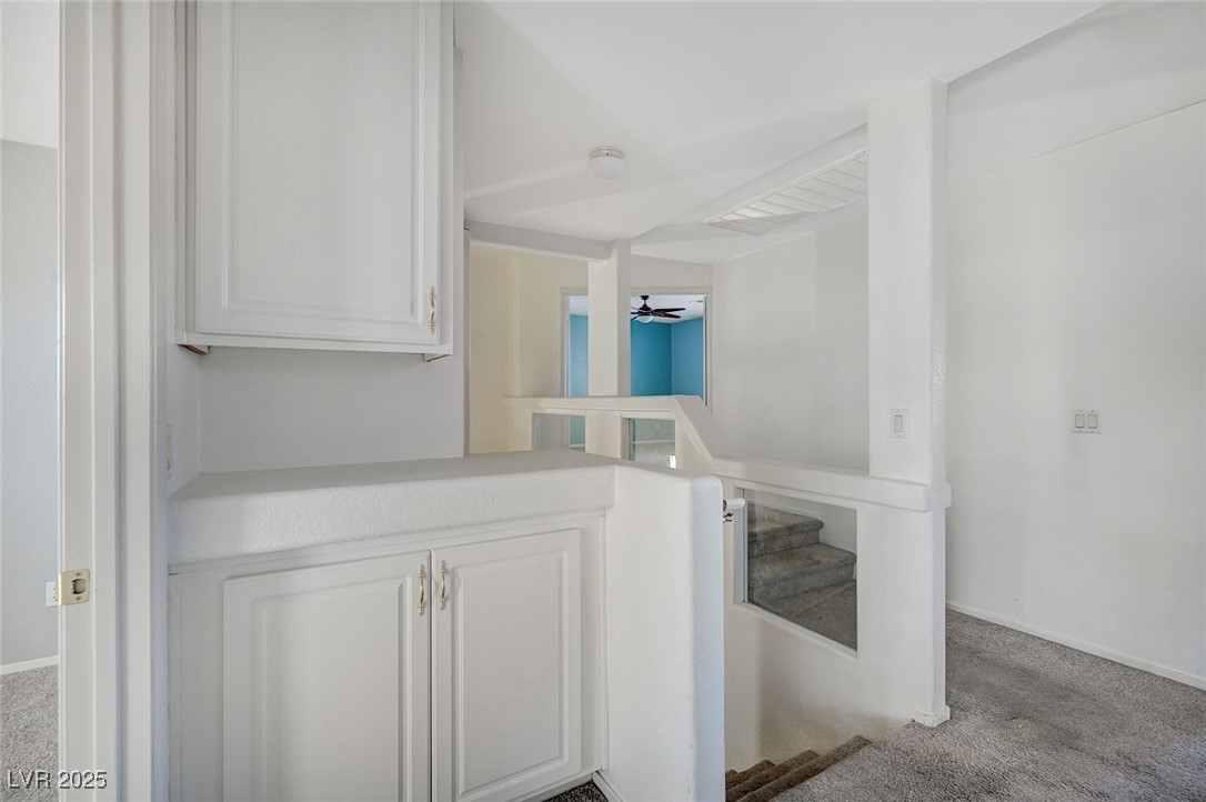8776 Country View Avenue Las Vegas, NV 89129 - Photo 29 of 43 Hallway with carpet and stairway