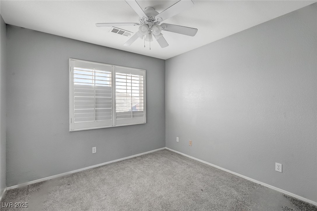 8776 Country View Avenue Las Vegas, NV 89129 - Photo 32 of 43 Carpeted spare room featuring baseboards and ceiling fan