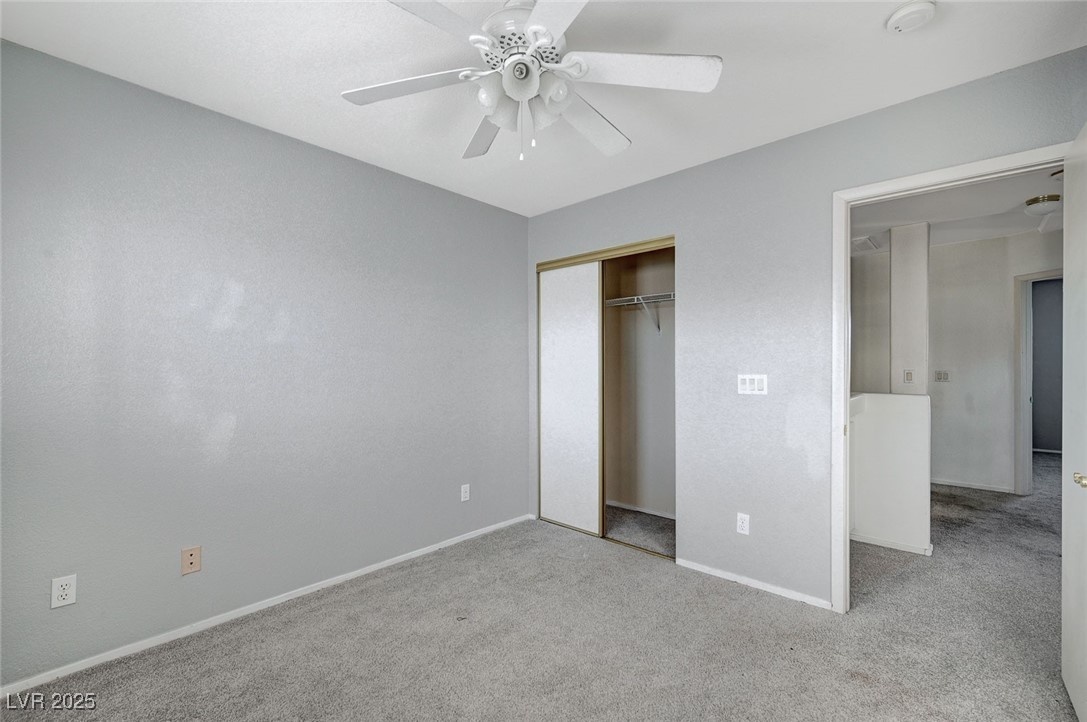 8776 Country View Avenue Las Vegas, NV 89129 - Photo 33 of 43 Unfurnished bedroom featuring light colored carpet, a closet, and a ceiling fan