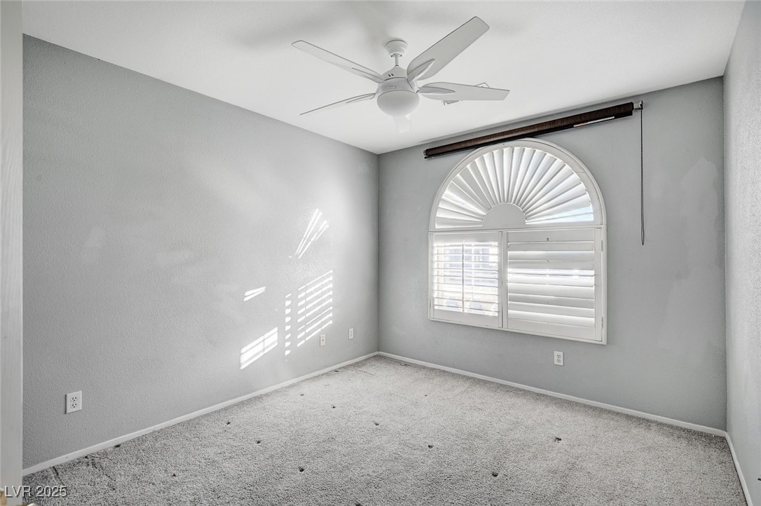 8776 Country View Avenue Las Vegas, NV 89129 - Photo 36 of 43 Empty room featuring carpet and a ceiling fan