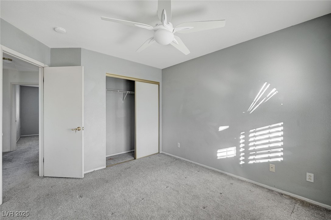 8776 Country View Avenue Las Vegas, NV 89129 - Photo 37 of 43 Unfurnished bedroom with carpet, ceiling fan, and a closet