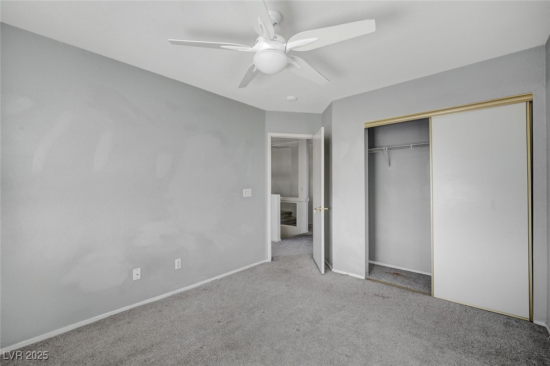 8776 Country View Avenue Las Vegas, NV 89129 - Photo 38 of 43 Unfurnished bedroom with carpet floors, a closet, and a ceiling fan