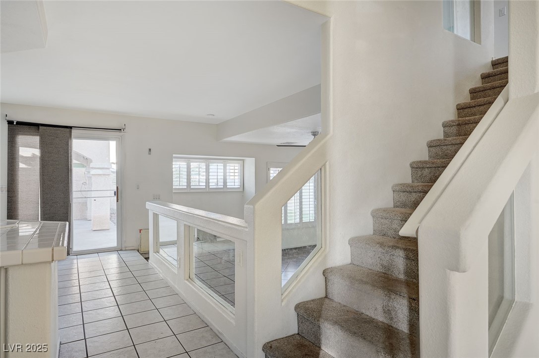 8776 Country View Avenue Las Vegas, NV 89129 - Photo 7 of 43 Stairway with tile patterned flooring