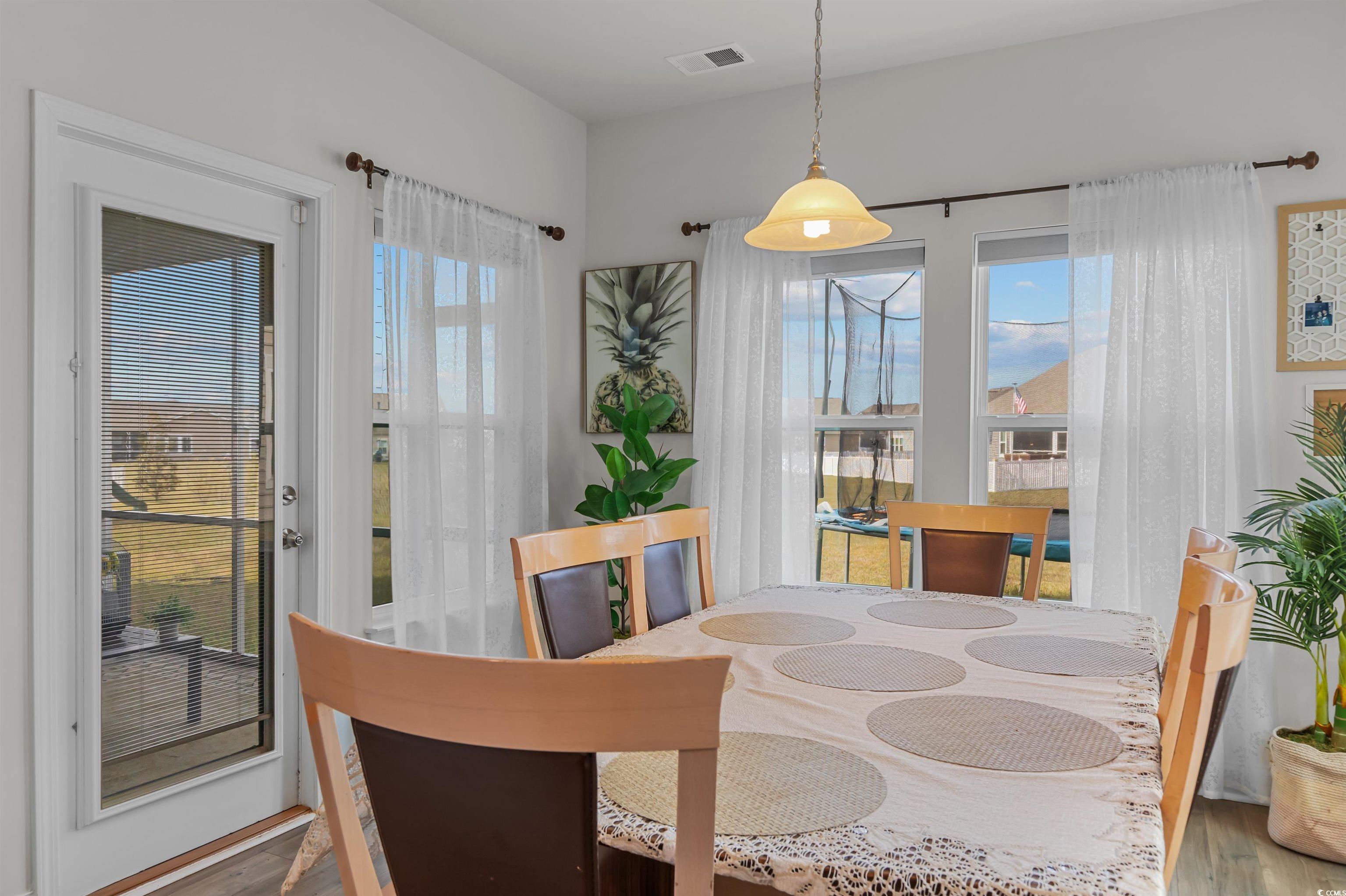 1176 HARBISON Circle Myrtle Beach, SC 29579 - Photo 19 of 40 Dining space featuring visible vents and wood finished floors