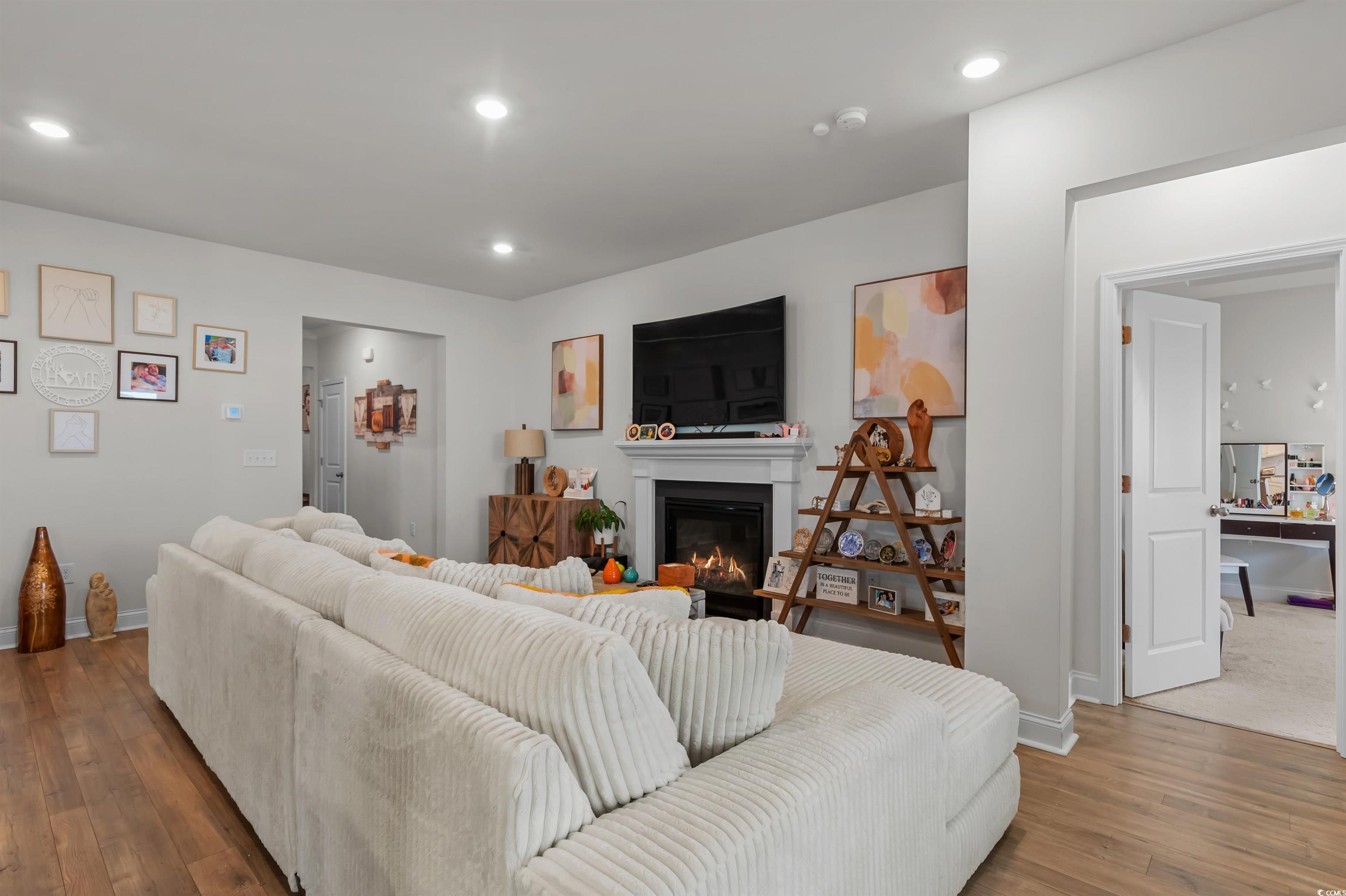 1176 HARBISON Circle Myrtle Beach, SC 29579 - Photo 20 of 40 Living area with wood finished floors, recessed lighting, and a glass covered fireplace