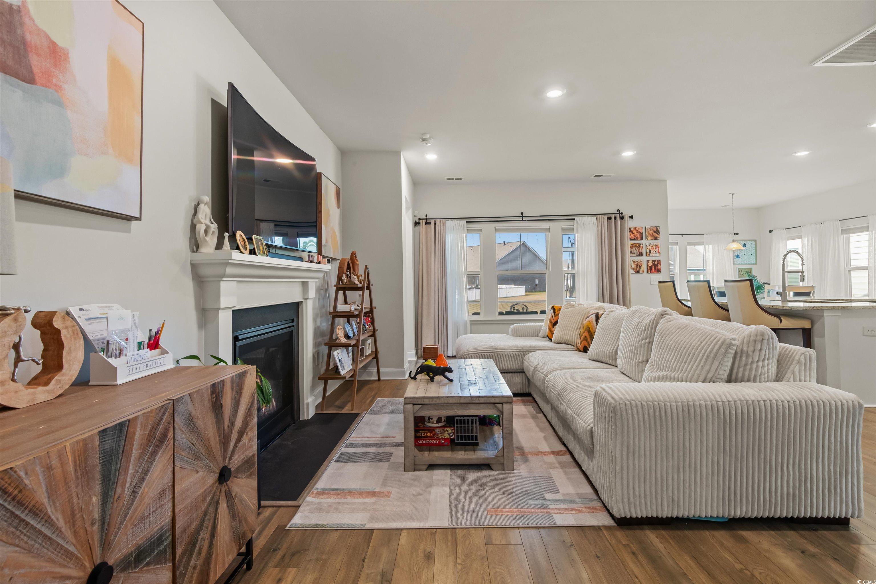 1176 HARBISON Circle Myrtle Beach, SC 29579 - Photo 10 of 40 Living room with recessed lighting, a glass covered fireplace, and wood finished floors