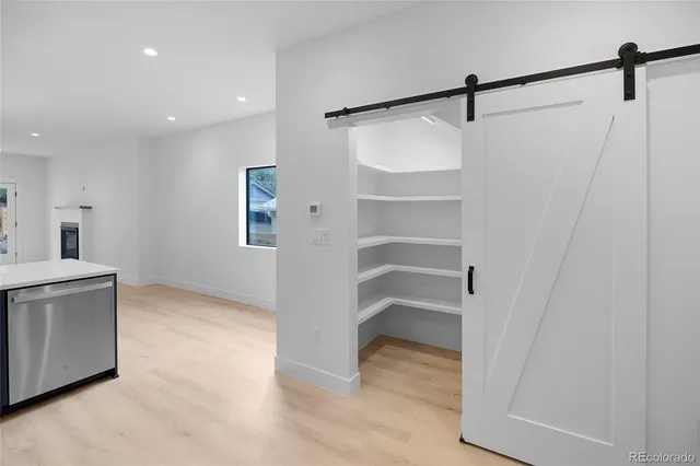 a view of a balcony with wooden floor and fence
