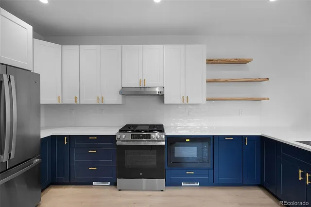 a kitchen with stainless steel appliances a sink stove and refrigerator