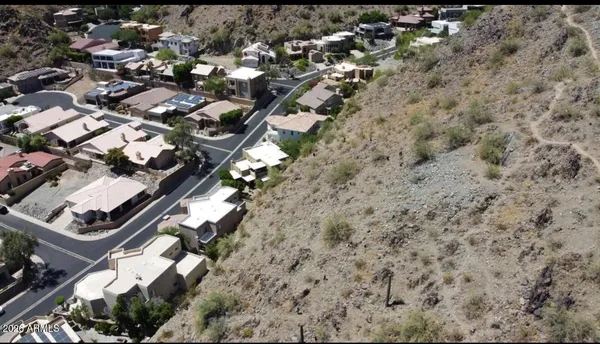 an aerial view of a residential houses with yard