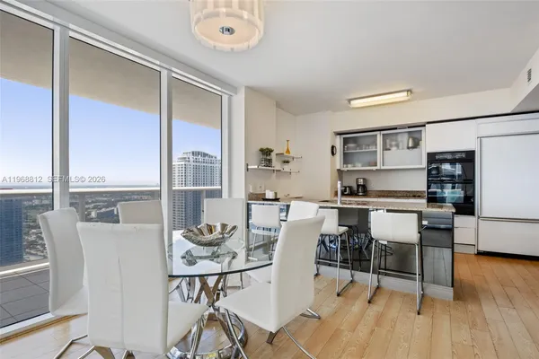 a view of a dining room with furniture window and wooden floor