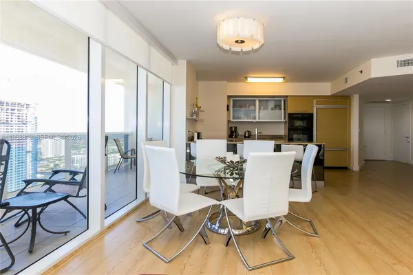 a view of a dining room with furniture window and wooden floor
