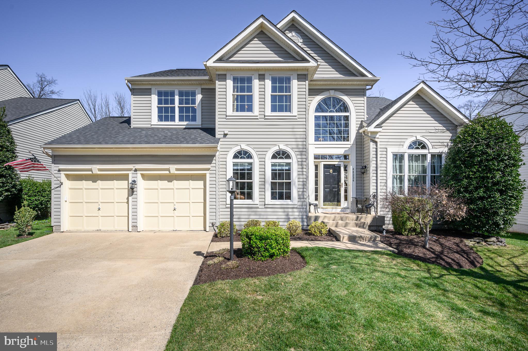 44334 Ladiesburg Place Ashburn, VA 20147 - Photo 1 of 52 a front view of a house with a yard and garage