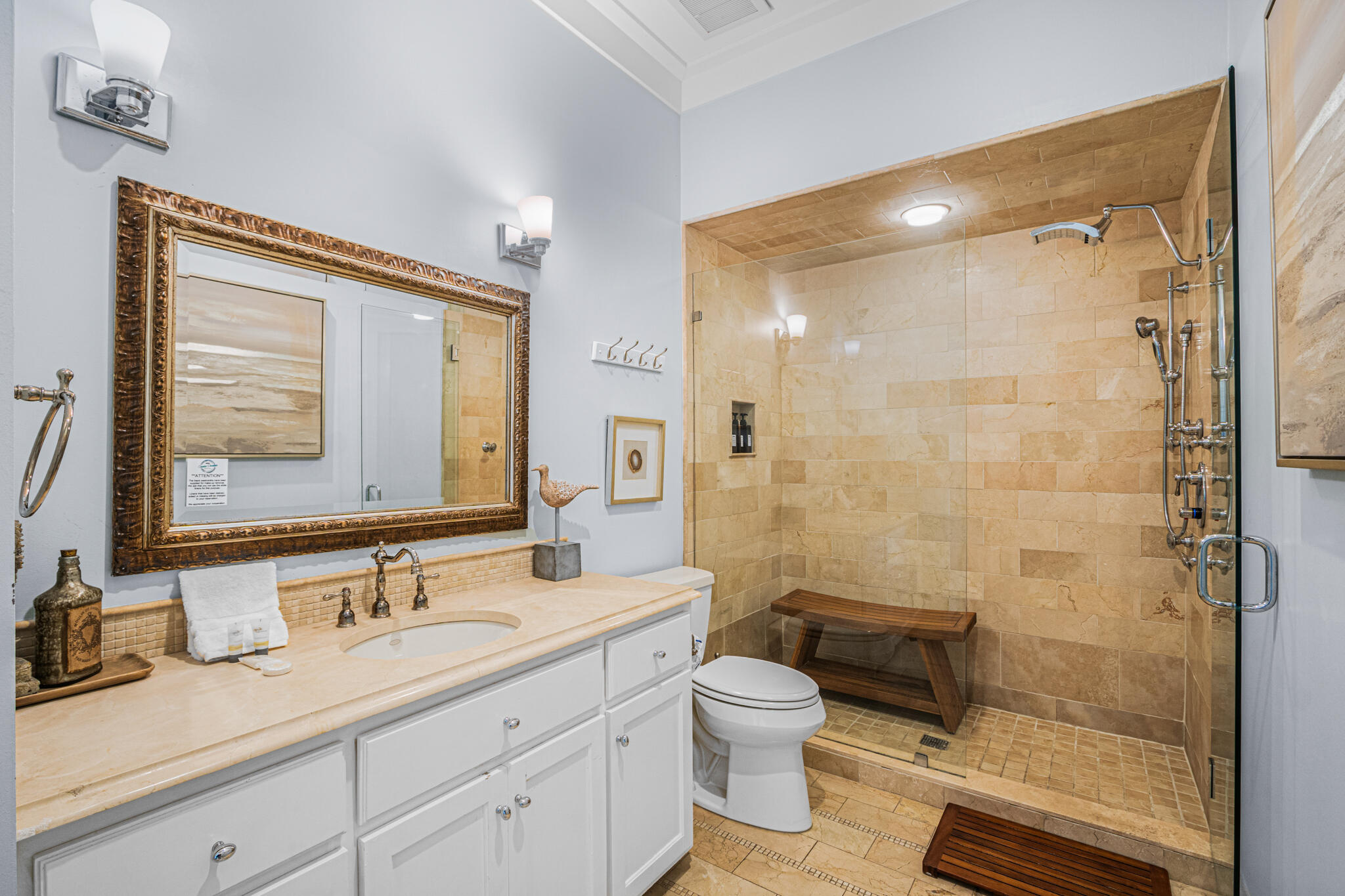 5231 East County Highway 30A, Unit D Santa Rosa Beach, FL 32459 - Photo 12 of 42 a bathroom with a granite countertop sink a mirror a toilet and shower