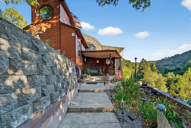 a dining room with wooden floor a chandelier a wooden table and chairs