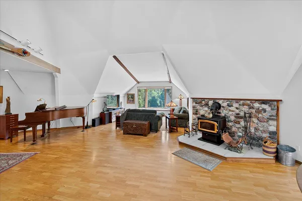 a living room with furniture stove and a wooden floor