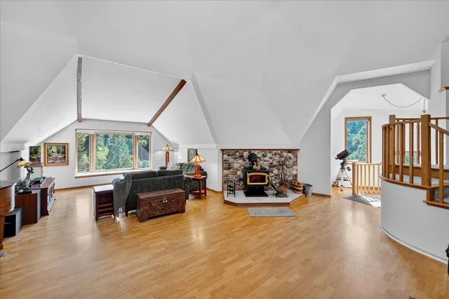 a living room with fireplace furniture and a dining table