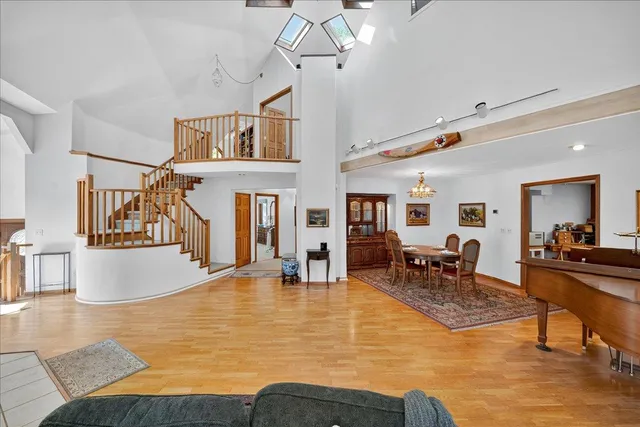 a living room with furniture a wooden floor and a flat screen tv