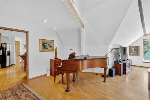 a bedroom with furniture and a chandelier fan