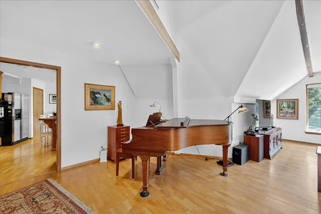 a bedroom with furniture and a chandelier fan
