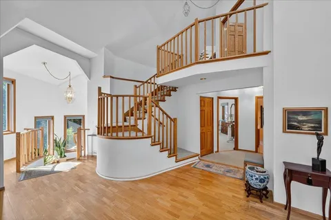 a bedroom with a bed a dresser and chair