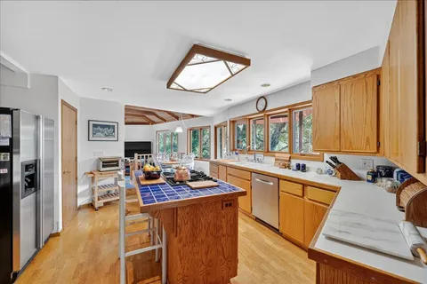 a view of a patio with table and chairs potted plants