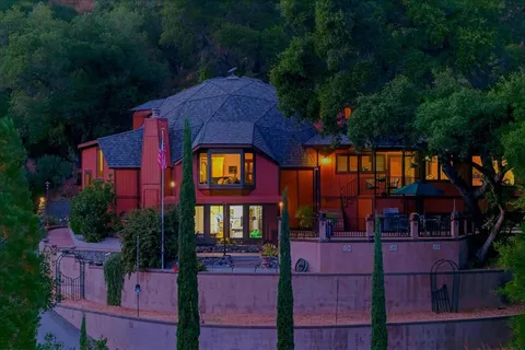 an aerial view of a house with a yard and garden