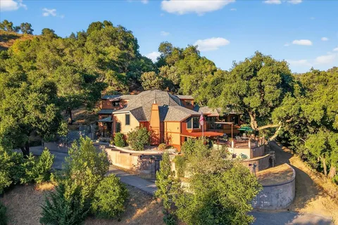 a living room with furniture a flat screen tv and a floor to ceiling window