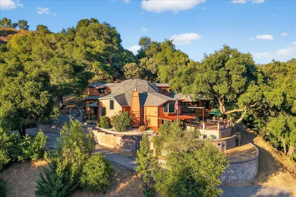 a living room with furniture a flat screen tv and a floor to ceiling window