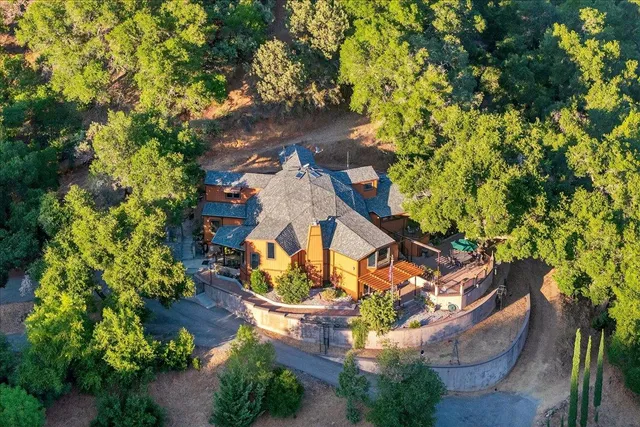 a living room with furniture and a dining table with wooden floor