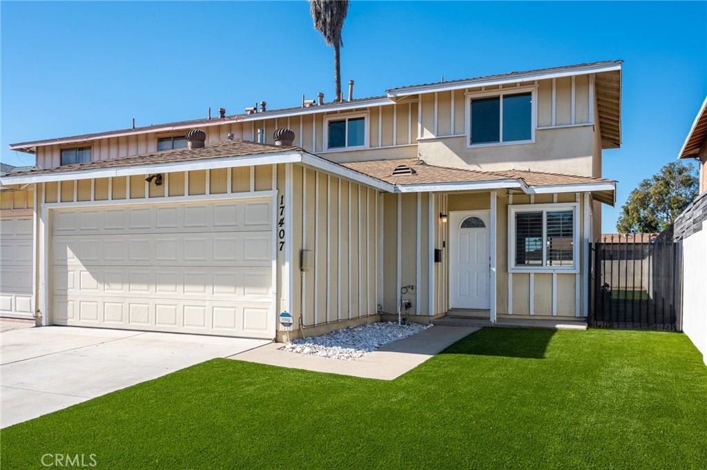 a front view of a house with a garden and yard