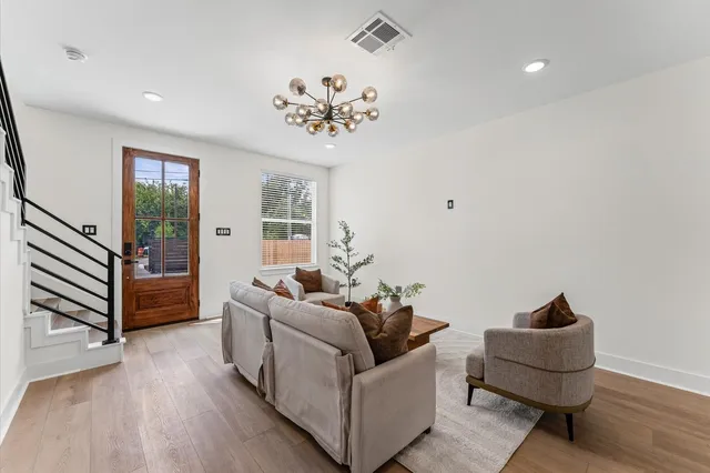 a living room with furniture and a chandelier