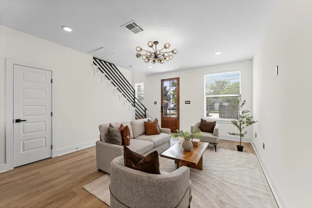 a living room with furniture and wooden floor